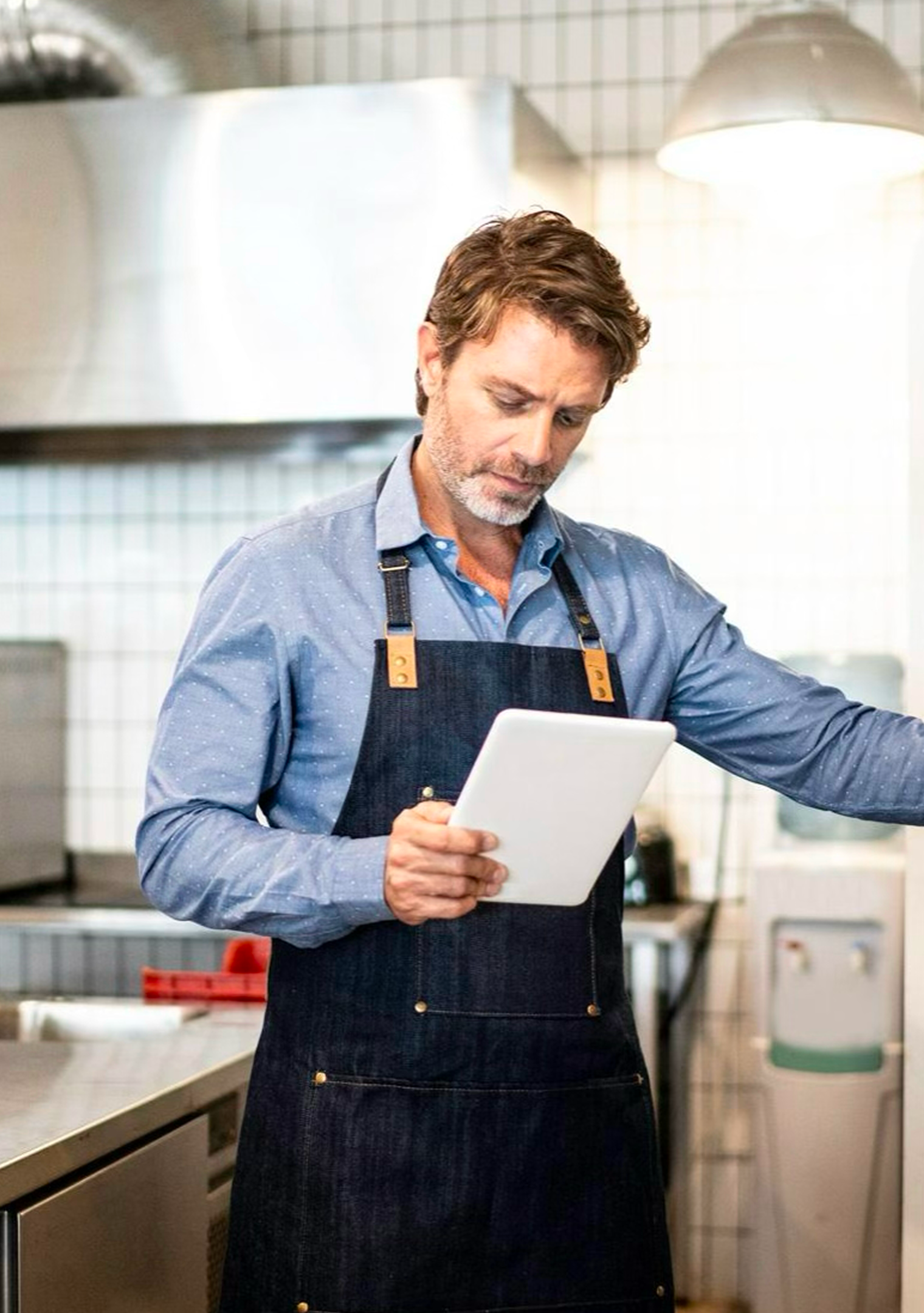 A chef in a kitchen using LinkedEats software